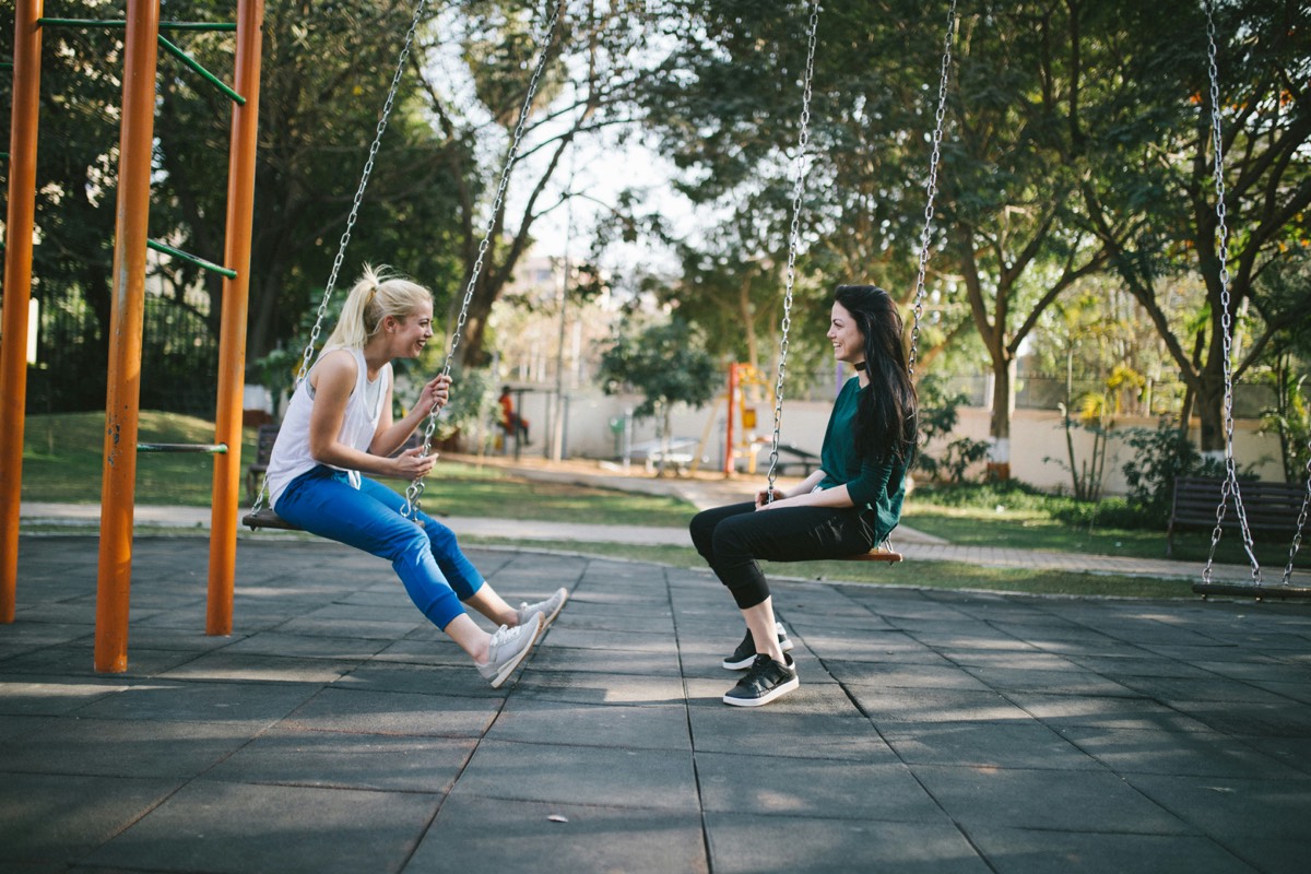 Girls playing on swings
